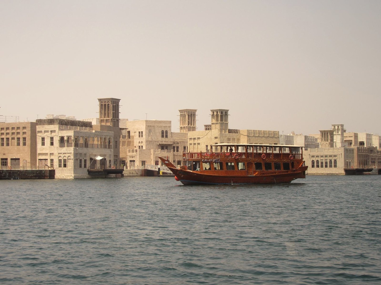 A wooden dhow cruising past Al Seef
