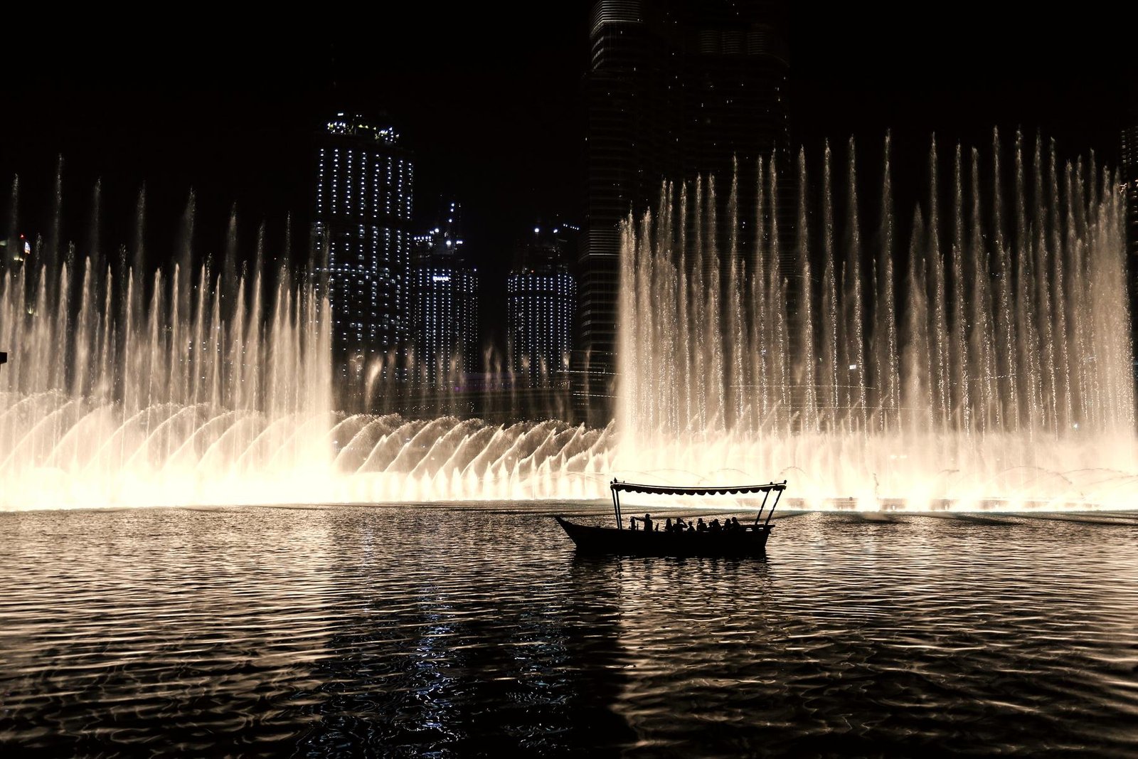 An abra on the Burj Lake during the fountain show
