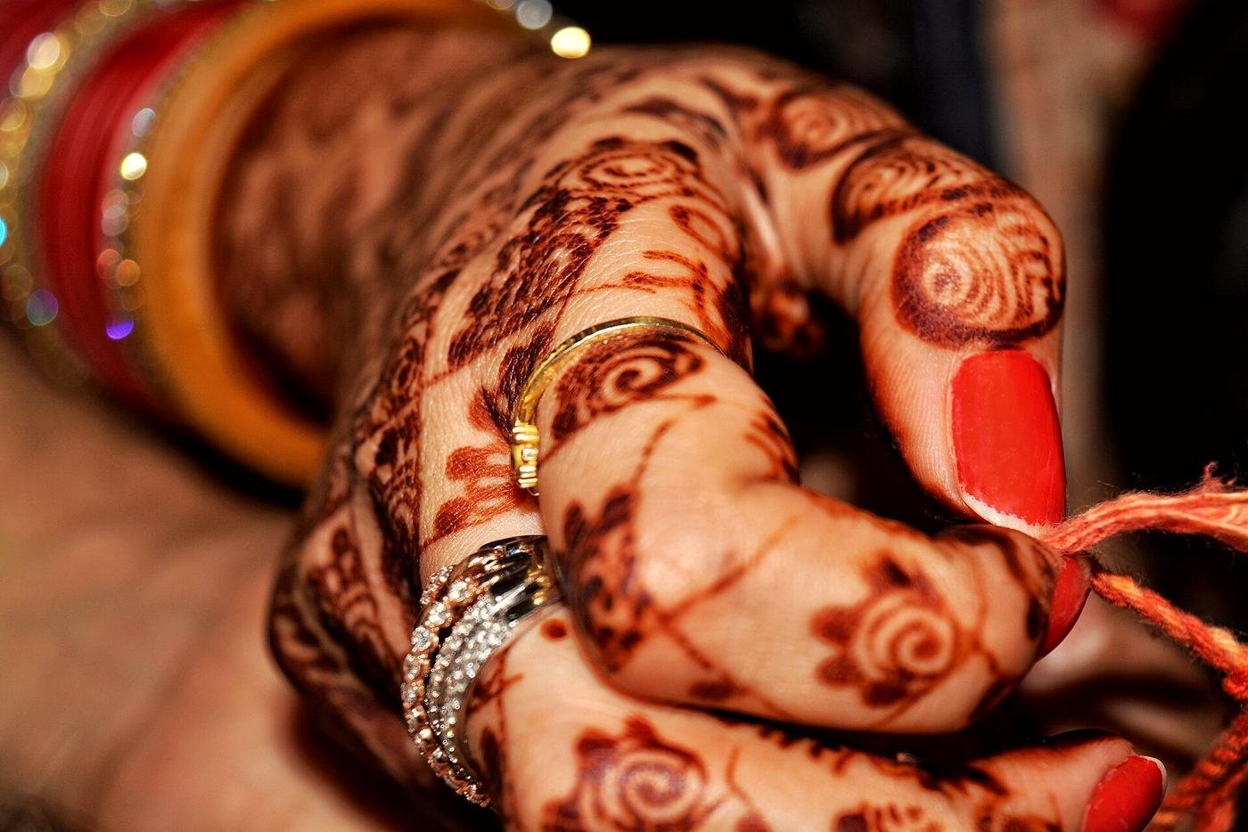A bride’s hand with intricate henna