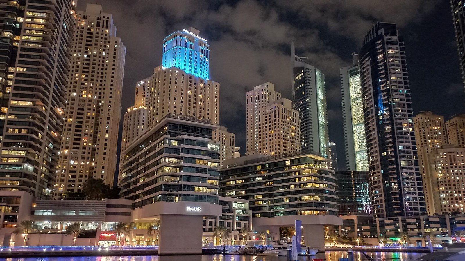 Dubai Marina towers reflected in the water at night