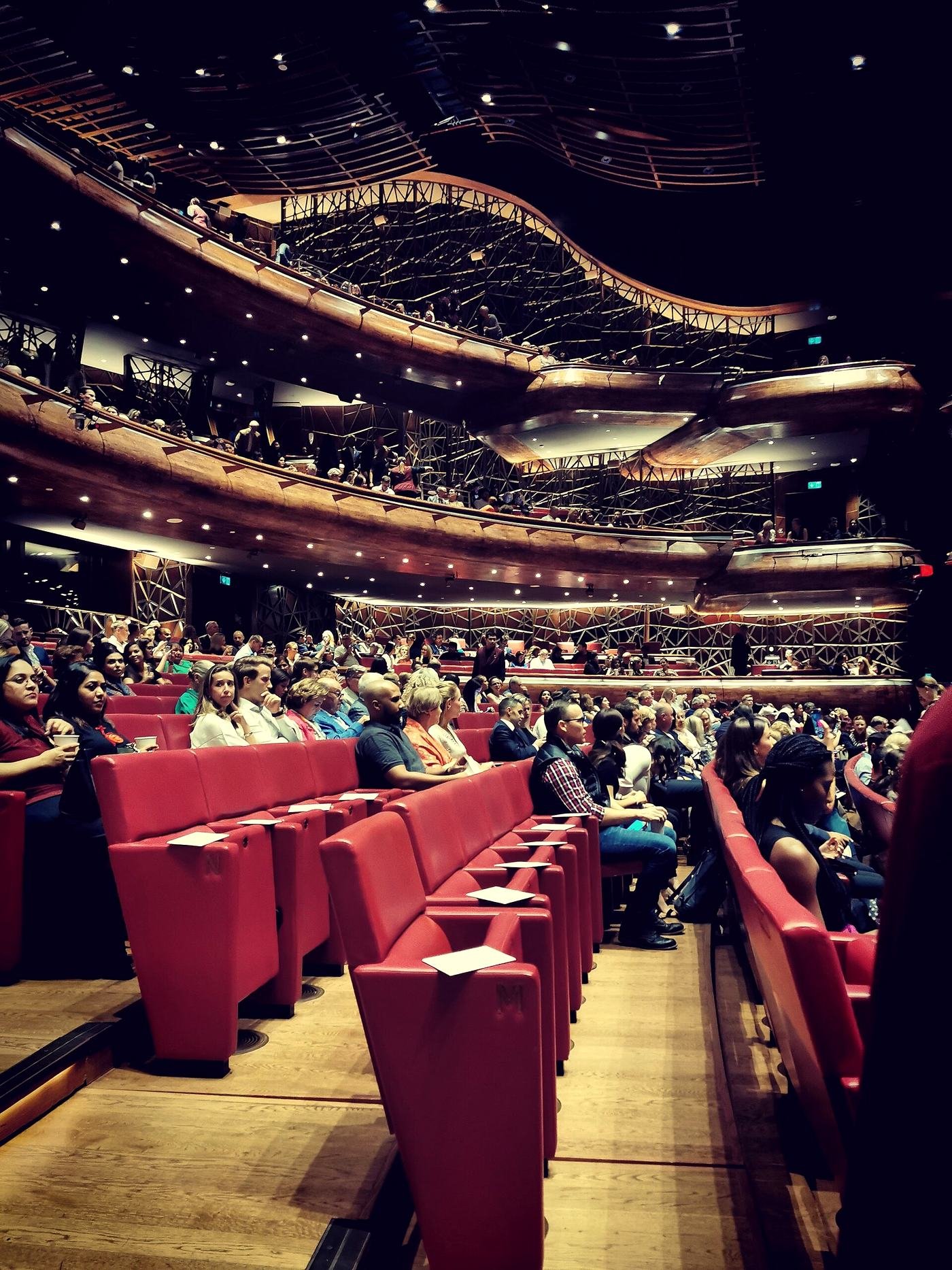 An auditorium filling before a performance